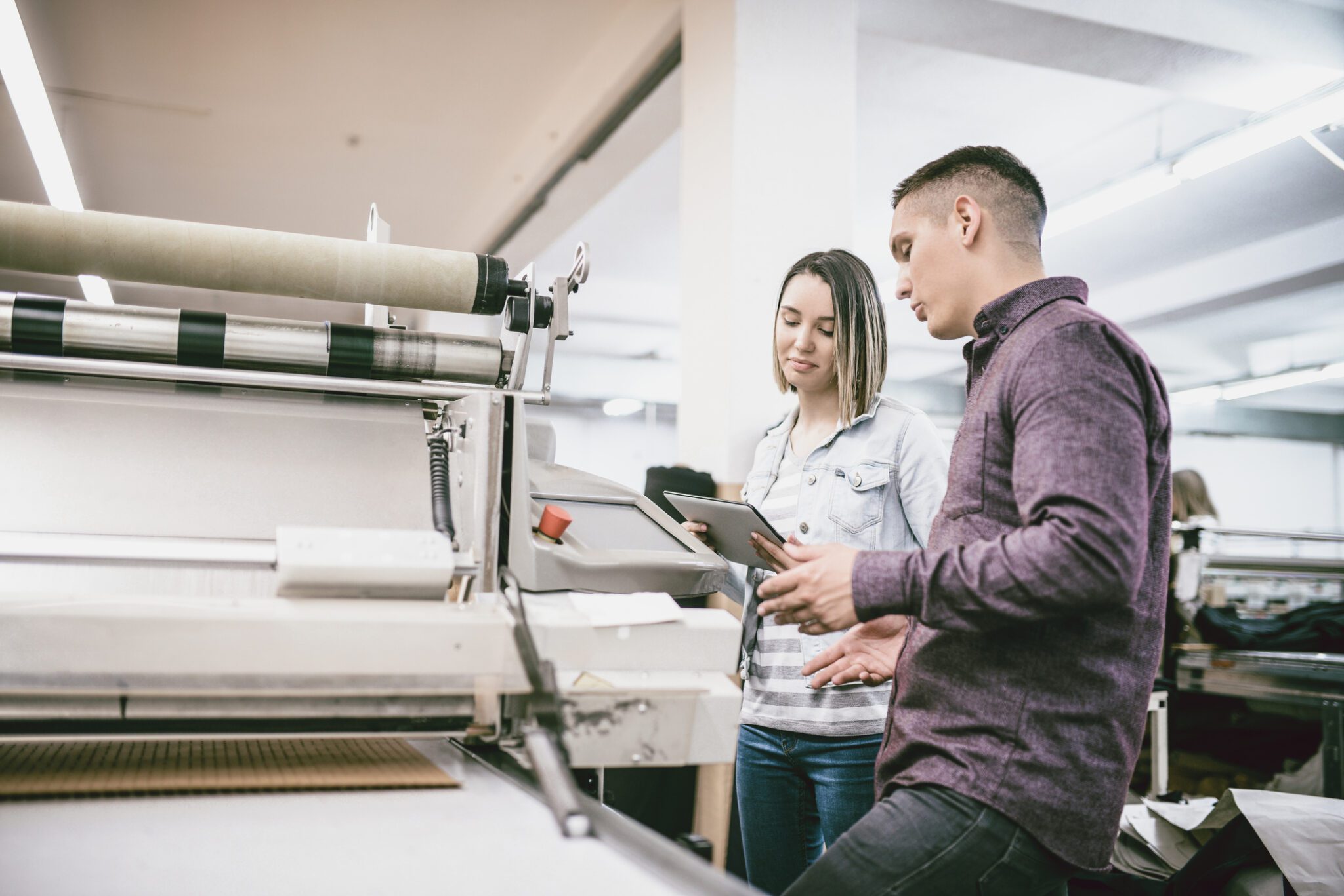 Team collaborating near industrial machine